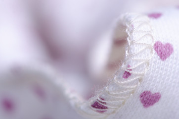 White fabric with heart pattern textile material texture blur background