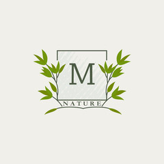 Green eco letters M logo with leaves in square shape. Initials with botanical elements with floral letter design for business identity style