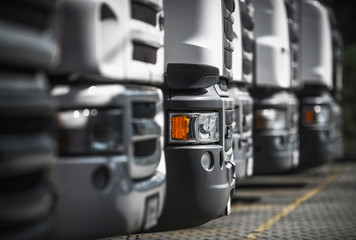 Fototapeta na wymiar Line of New and Pre-Owned Semi Trucks