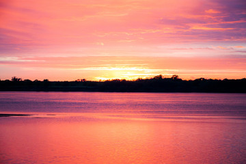 Sunset on the river Bank in clouds
