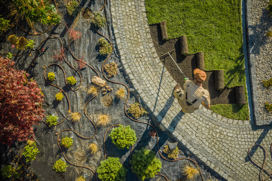 New Residential Garden Developing By Caucasian Landscaping Worker