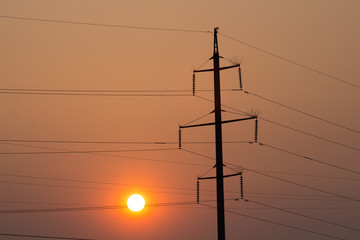High voltage towers on the sunset time
