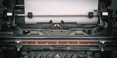 Close-up of old typewriter with blank paper - vintage background