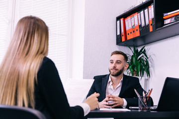 successful young man smiling to woman after successful negotiati