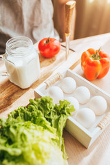 Fresh natural products on the morning table - vegetables, milk and eggs - no GMOs