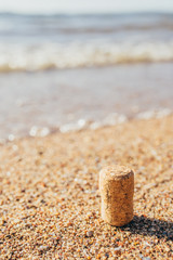 Cork from a bottle of wine on the sandy beach of the sea shore - a mysterious message in a bottle of lost on the island - sea adventures