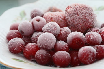 Frozen cherries and strawberries on a white plate
