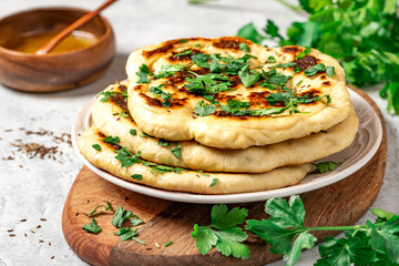 Freshly baked homemade flatbread with oil, spices and parsley. Traditional homemade wheat flour...