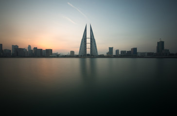 Fototapeta na wymiar MANAMA, BAHRAIN - DECEMBER 30: The Bahrain World Trade Center during sunrise, a twin tower complex is the first skyscraper in the world to have wind turbines, December 30, 2017, Manama, Bahrain