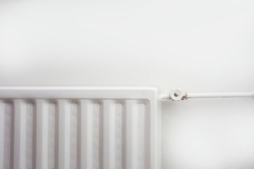 Close up of radiator against white wall modern new retro design.