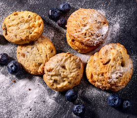Bakers gonna bake. Serving food on slate. Oatmeal cookies biscuit with blueberry on dark tiles countrylike. Chocolate chip cookies shop on window display. Beautiful table setting.