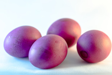 Photo of the close-up color purple egg in a white  background.