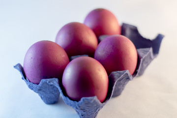 Photo of the close-up color purple egg in a white  background.