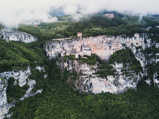Aerial view by drone of Madonna della Corona Sanctuary church, Italy. Amazing beautiful italian place and landscape. Historical and medieval building in the rock and mountain. Postcard concept. 