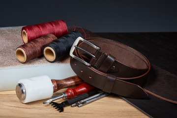  Leather crafting tools with handmade belt on a used Die Cutting Board. Set of leather craftsman...