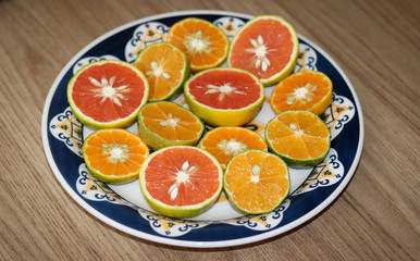 Beautiful lemons, bergamots and grapefruits cut in half on a cutting board.