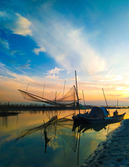 Fishing net with boats during Sunset at the river Brahmaputra in Majuli Island, Assam.