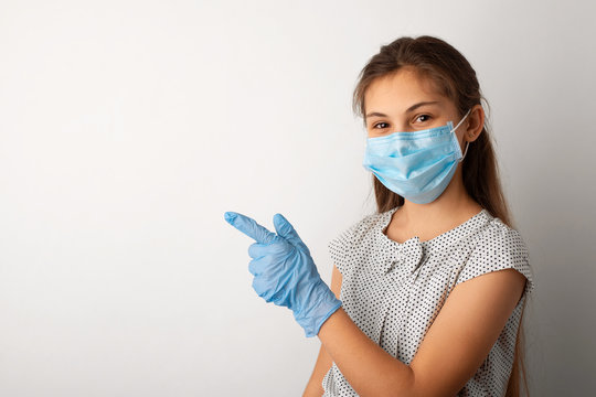 Small girl in protective mask and gloves with copy space for inscription. Concept of coronavirus epidemic