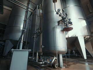Drinking water factory production, industrial interior. Large metal tanks for filtering and potable water treatment from well.