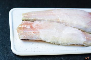 raw fish frozen fillet hake ice Menu concept healthy eating. food background top view copy space keto or paleo diet, pascarian