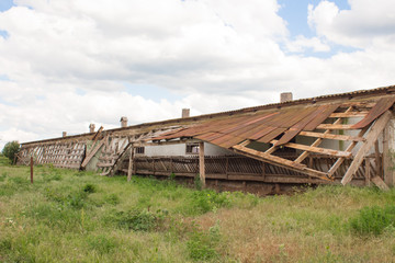  Damaged slate old roof. A hole in a boned roof close-up