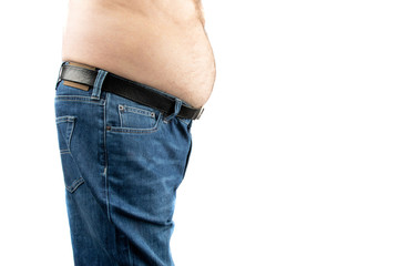 a man wearing blue denim jeans with a large beer belly protruding isolated on white