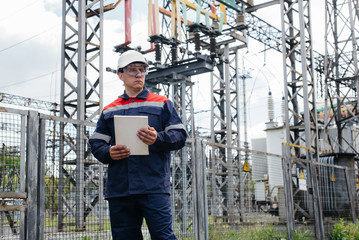 Fototapeta na wymiar The energy engineer inspects the equipment of the substation. Power engineering. Industry