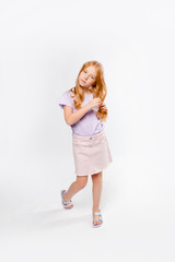 red-haired girl braids her hair