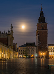 Naklejka premium Krakow, Poland, main square night view with full moon