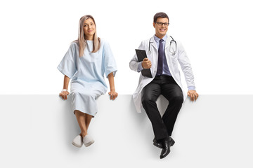 Male doctor and a female patient sitting on a blank panel