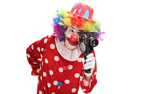 Clown holding a vintage camera