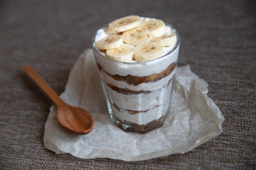 Homemade tiramisu without sugar with a banana and a wooden spoon. Healthy eating. Home cooking. We cook in self-isolation. Diet. Low in calories.