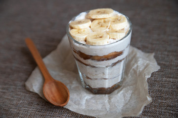 Homemade tiramisu without sugar with a banana and a wooden spoon. Healthy eating. Home cooking. We cook in self-isolation. Diet. Low in calories.