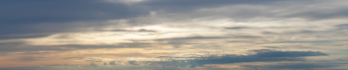 Fototapeta premium Panorama of dark cloudy dramatic sky at sunset