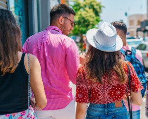 Tourists sightseeing and walking at a modern city boardwalk on a beautiful sunny summer day.