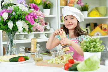 Portrait of cute girl preparing delicious fresh salad