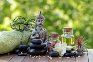 Obraz na płótnie Canvas Spa and wellness composition with statuette of Buddha, zen stones, oil and salt