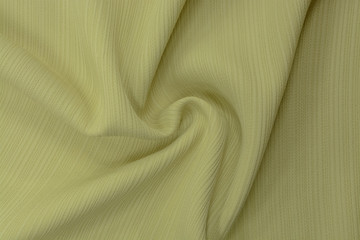 Texture of cool polyester fabric. Background of green yellow textile