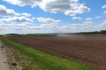 Fototapeta na wymiar tractor plows a field in spring