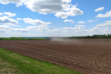 Fototapeta na wymiar tractor plows a field in spring