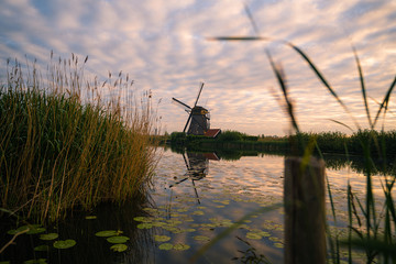 Amazing sunrise of beautiful windmills at Kinderdijk, The Netherlands during sunrise, no tourists due to Covid-19