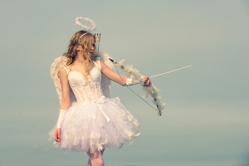 Portrait of a cupid little girl. Innocent girl. Space for text. arrow and wings. Cherub girl....