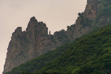 Wushan, Hubei, China - May 7, 2010: Wu Gorge in Yangtze River. Sharp brown-black rocky mountain...