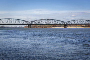 Fototapeta premium River Vistula with bridge of Josef Pilusdski in Torun city, Poland