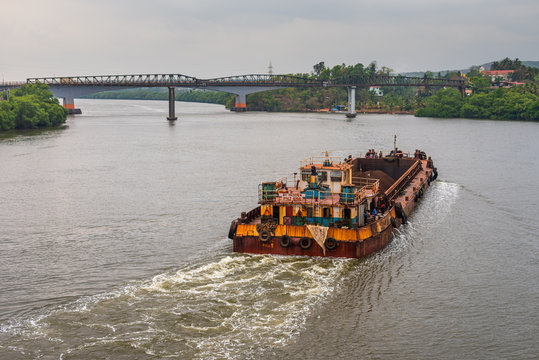 Borim,Goa/India- May 1 2020: Barges carrying mining ore for export at Borim, Goa.