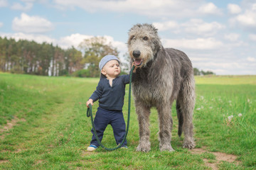 Little boy walking his dog.