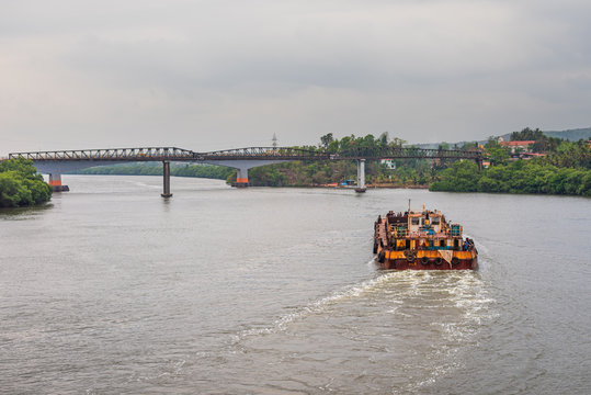 Borim,Goa/India- May 1 2020: Barges carrying mining ore for export at Borim, Goa.
