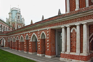 Moscow / Russia – 07 16 2019: Grand Palace right side arch wall with columns on tower background in Tsaritsino Park Museum on summer day, architecture ancient landmark