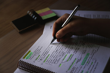 student at his desk preparing an exam