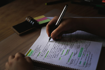 student at his desk preparing an exam